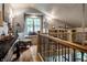 Cozy loft area featuring a window seat, decorative lighting, and views of the home's interior at 140 4Th Nw St, Carmel, IN 46032