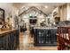 Open kitchen and living space featuring vaulted ceiling, modern furnishings and hardwood floors at 140 4Th Nw St, Carmel, IN 46032