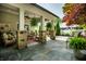 Inviting covered patio with stone columns, ceiling fan, and comfortable seating area at 140 4Th Nw St, Carmel, IN 46032