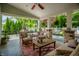 Comfortable outdoor patio with stone columns, ceiling fan, and seating area at 140 4Th Nw St, Carmel, IN 46032