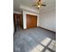 This carpeted bedroom features a ceiling fan and double-door closet at 1421 S Meridian St, Indianapolis, IN 46225