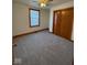 Neutral bedroom with ceiling fan, plush carpet, window, and a closet with wood doors at 1421 S Meridian St, Indianapolis, IN 46225