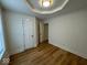 Bright bedroom with recessed ceiling, wood-look flooring, and two doors for entry at 1421 S Meridian St, Indianapolis, IN 46225