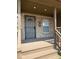 Front porch view with brick accents, secured front door, and a small window for natural lighting at 1421 S Meridian St, Indianapolis, IN 46225