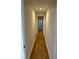 Hallway with modern wood-look flooring and white walls leading to other rooms at 1421 S Meridian St, Indianapolis, IN 46225