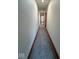 Long carpeted hallway with neutral walls and overhead lighting at 1421 S Meridian St, Indianapolis, IN 46225