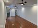 Bright living room with hardwood floors, white walls, recessed lighting, and staircase access at 1421 S Meridian St, Indianapolis, IN 46225