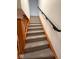 Carpeted staircase with wooden and black metal railings for safety and style at 1421 S Meridian St, Indianapolis, IN 46225