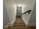 Carpeted staircase with black handrail and white walls leads upstairs at 1421 S Meridian St, Indianapolis, IN 46225
