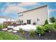 A lovely backyard featuring a concrete patio, lush landscaping, and access to the house at 14514 Glapthorn Rd, Fishers, IN 46037