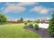 Expansive backyard featuring a well-manicured lawn, patio, and landscaped garden beds at 14514 Glapthorn Rd, Fishers, IN 46037