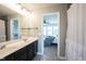 Bathroom featuring a double vanity and tile floor, with an ensuite bedroom at 14514 Glapthorn Rd, Fishers, IN 46037
