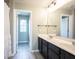 Bathroom featuring a double vanity, tile floor, and shower-tub combination at 14514 Glapthorn Rd, Fishers, IN 46037