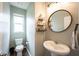 Stylish half-bathroom featuring pedestal sink, decorative shelves and modern lighting at 14514 Glapthorn Rd, Fishers, IN 46037