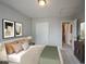 This bedroom features neutral walls, carpet, closet, bathroom entrance, and abstract artwork at 14514 Glapthorn Rd, Fishers, IN 46037