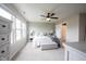 Bright bedroom with three windows, ceiling fan, and neutral décor with ensuite bathroom at 14514 Glapthorn Rd, Fishers, IN 46037
