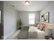 This bedroom features neutral walls, carpet, one window, a houseplant, and minimalist artwork at 14514 Glapthorn Rd, Fishers, IN 46037