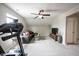 Finished bonus room with a treadmill, television and casual seating under a ceiling fan at 14514 Glapthorn Rd, Fishers, IN 46037
