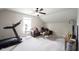 Bonus room features a treadmill, comfortable seating, and neutral decor at 14514 Glapthorn Rd, Fishers, IN 46037
