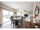 The dining area features a round wooden table, with views of the backyard through sliding glass doors at 14514 Glapthorn Rd, Fishers, IN 46037