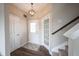 Cozy entryway with wood-look floors, a staircase, a pendant light, and convenient access to other rooms at 14514 Glapthorn Rd, Fishers, IN 46037