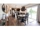 An open kitchen features dark cabinetry, stainless steel appliances, and dining area at 14514 Glapthorn Rd, Fishers, IN 46037