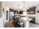 Bright kitchen features white countertops, dark cabinets, stainless steel appliances, and an island with bar seating at 14514 Glapthorn Rd, Fishers, IN 46037