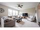 Bright living room featuring a comfy sectional sofa, large windows, and a stylish entertainment center at 14514 Glapthorn Rd, Fishers, IN 46037