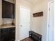 Hallway with coat rack, bench, and cabinets, creating an organized space at 14514 Glapthorn Rd, Fishers, IN 46037