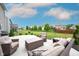 Inviting outdoor patio with cushioned seating and views of the well-maintained backyard at 14514 Glapthorn Rd, Fishers, IN 46037
