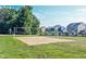Outdoor sand volleyball court with net and views of nearby homes and green space at 14514 Glapthorn Rd, Fishers, IN 46037
