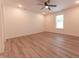 Spacious bedroom featuring hardwood floors, a ceiling fan, and natural light from a bright window at 1452 Coen Ct, Columbus, IN 47201