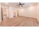 Bright bedroom with light hardwood floors, ceiling fan, walk-in closet, and ensuite bathroom access at 1452 Coen Ct, Columbus, IN 47201