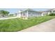 Well-maintained townhome with attached garage, green lawn, and sidewalk at 1452 Coen Ct, Columbus, IN 47201