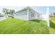 Exterior view of a gray vinyl sided townhome with a green lawn and white fence at 1452 Coen Ct, Columbus, IN 47201