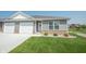 Charming home featuring a one car garage, landscaped front yard, and brick facade at 1452 Coen Ct, Columbus, IN 47201