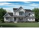 Charming two-story home with stone accents, inviting porch, and beautifully landscaped front yard at 1465 Old Hickory Ln, Westfield, IN 46074