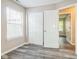 Bedroom with wood-look floors, closet space, and a window offering natural light at 14911 Silver Thorne Way, Carmel, IN 46033