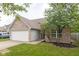 Charming single-Gathering home boasts a brick facade, attached garage, and a well-maintained front yard at 14911 Silver Thorne Way, Carmel, IN 46033