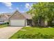 Charming single-Gathering home boasts a brick facade, attached garage, and a well-maintained front yard at 14911 Silver Thorne Way, Carmel, IN 46033