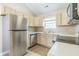 Functional kitchen with stainless steel appliances, light wood cabinetry, and ample counter space at 14911 Silver Thorne Way, Carmel, IN 46033