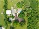 Aerial view of home with pool, outbuilding, detached garage, mature trees and long driveway at 15812 Joliet Rd, Westfield, IN 46074