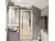Bathroom featuring tiled shower and gray color palette, with storage and modern fixtures at 15812 Joliet Rd, Westfield, IN 46074