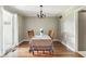 Formal dining room featuring hardwood floors, natural light, and stylish chandelier, perfect for entertaining guests at 15812 Joliet Rd, Westfield, IN 46074