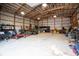 Spacious garage with metal walls, bright lighting, and ample storage for vehicles and equipment at 15812 Joliet Rd, Westfield, IN 46074