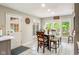 Eat-in kitchen area featuring a wood table, windows and an exterior access door at 15812 Joliet Rd, Westfield, IN 46074