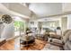 Cozy living room featuring a leather reclining sofa, hardwood floors, and natural light from sliding glass doors at 15812 Joliet Rd, Westfield, IN 46074