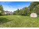 Expansive backyard surrounded by mature trees, offering privacy and shade at 1631 Wilford Ln, Indianapolis, IN 46229