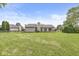 Spacious backyard with lush lawn and mature trees, perfect for outdoor enjoyment at 1631 Wilford Ln, Indianapolis, IN 46229