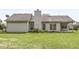 View of the backyard and covered patio, ideal for relaxing or entertaining at 1631 Wilford Ln, Indianapolis, IN 46229